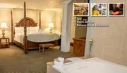 The image shows a luxurious hotel room with a four-poster bed, wooden furniture, and a bathroom, highlighting amenities like a spa, room service, and a balcony bar and restaurant.