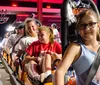 Two people are laughing joyfully while riding a mountain coaster