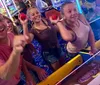 A family is happily playing a game of skee-ball in an arcade