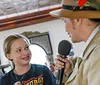 A lively dinner show scene with an engaging performer and guests enjoying their meals accompanied by positive reviews praising the food entertainment and service
