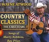 A man dressed in a patriotic outfit holds a guitar next to a sign that reads Ron Wayne Atwood Country Classics The Early Years featuring songs of Marty Robbins and Ray Price