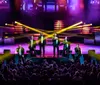 A group of singers performing on stage with a moody blue lighting setup