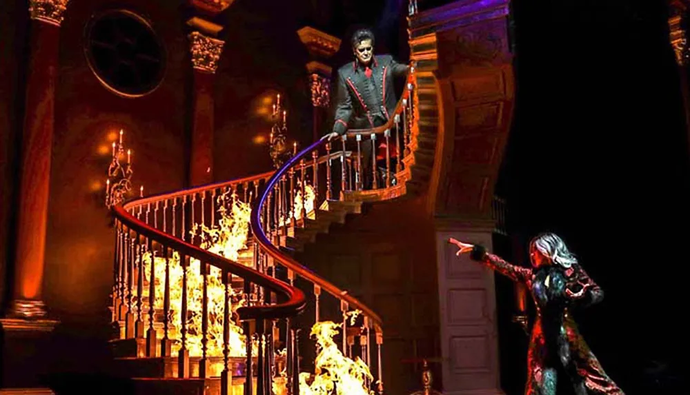 A dramatic scene features a person standing atop a fiery spiral staircase while another person points upwards in a dimly lit opulent setting
