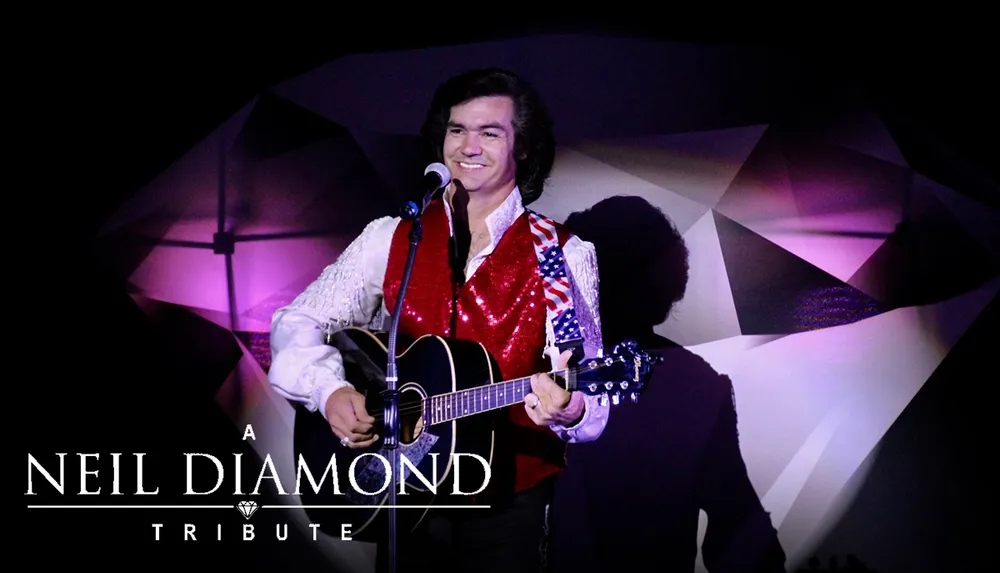 A performer in a sparkly red vest and white shirt is playing a guitar on stage under the banner A Neil Diamond Tribute