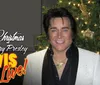 A person resembling Elvis Presley stands in front of a Christmas tree with a backdrop that reads Elvis Live
