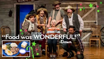 A group of people in Western wear are joyfully posing on a rustic set, embodying the festive spirit of a Christmas-themed event or production.