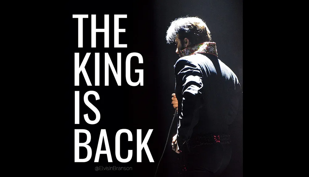 A person is standing on stage holding a microphone with the words THE KING IS BACK next to them