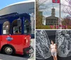 A red and blue trolley-style tour bus with passengers is parked on a city street under a clear sky