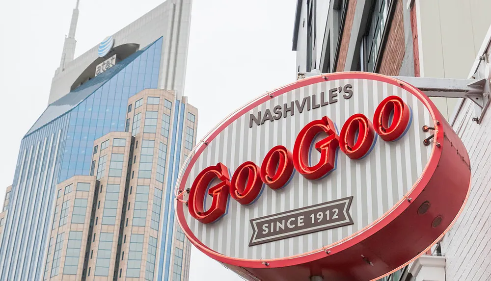 The image shows a large circular sign with Nashvilles GooGoo in red letters indicating a local business with a skyscraper in the background