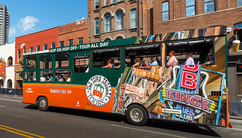 A colorful sightseeing trolley bus labeled Old Town Trolley Tours offers a hop-on hop-off experience for tourists on a sunny day in a bustling urban area