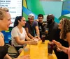 A group of cheerful people are toasting with drinks in a lively bar setting