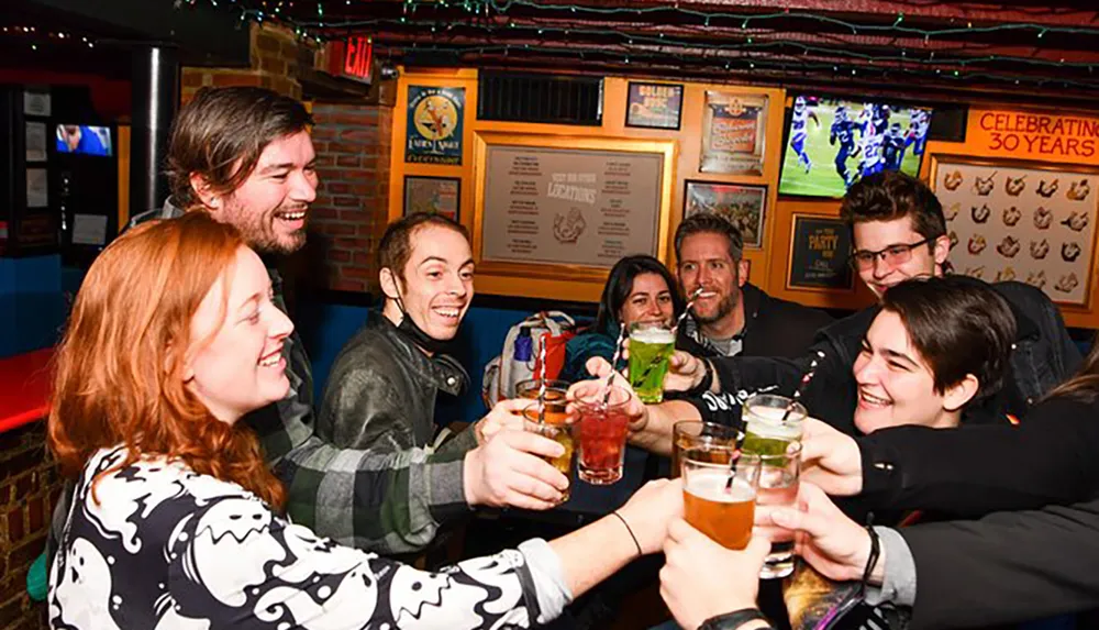 A group of cheerful people are toasting with drinks at a cozy festive bar