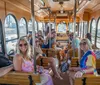 A trolley-style bus marked Music City BrewHop is parked in front of a building with classical Greek architecture