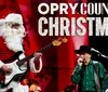 A person dressed as Santa Claus plays an electric guitar on stage during the Opry Country Christmas event