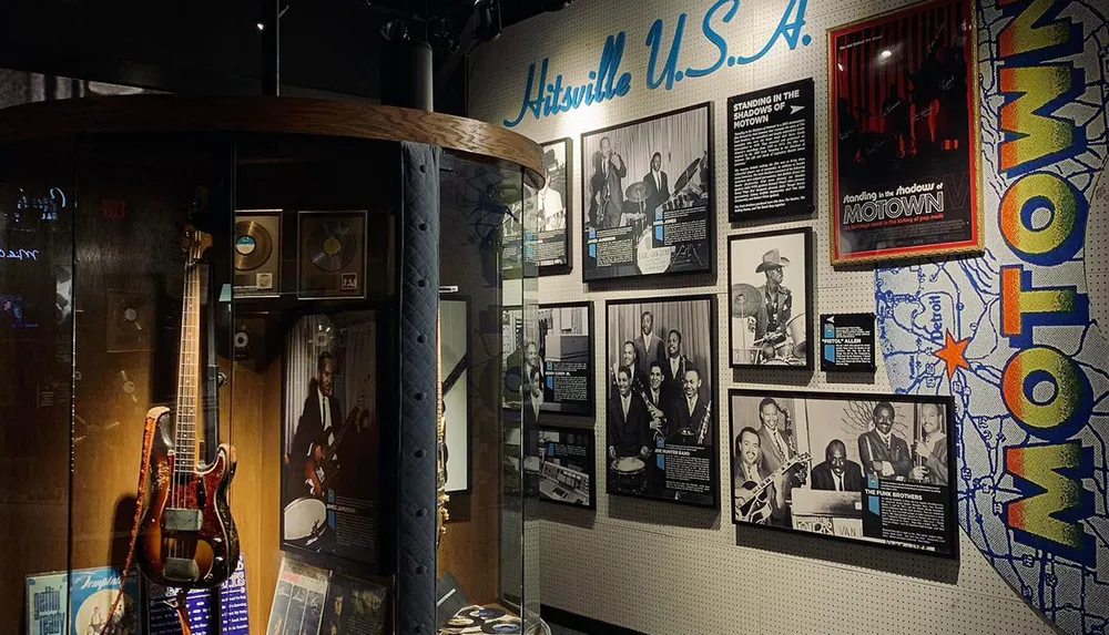 The image shows an exhibit displaying memorabilia and images related to the Motown music genre and artists with Hitsville USA prominently featured on the wall