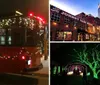 A trolley bus adorned with festive holiday lights is parked in the evening