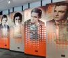 The image shows a series of large panels displaying monochromatic portraits of four different men with years from 1930 to 1960 accompanied by a pattern of white circles overlaying the right side of each image