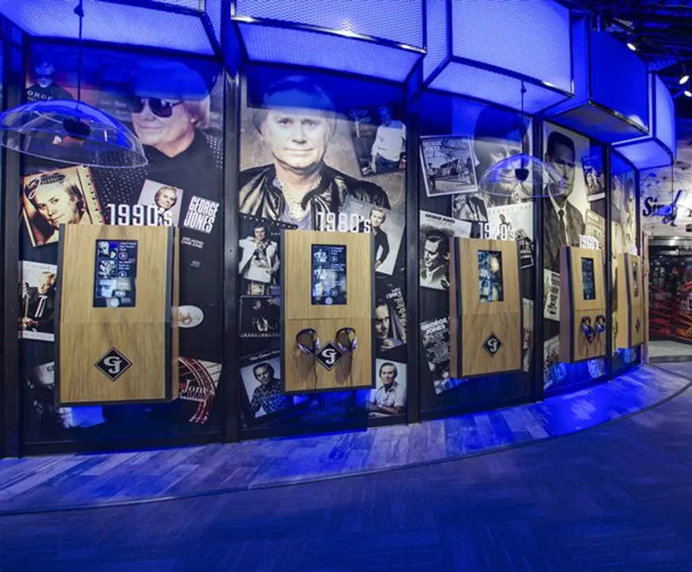 The image showcases a display with various memorabilia and photographs likely dedicated to the career of a musician or celebrity spanning across different decades from the 1950s to the 1990s