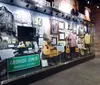 The image shows a museum display featuring memorabilia including guitars clothing and photographs dedicated to the legacy of a musician