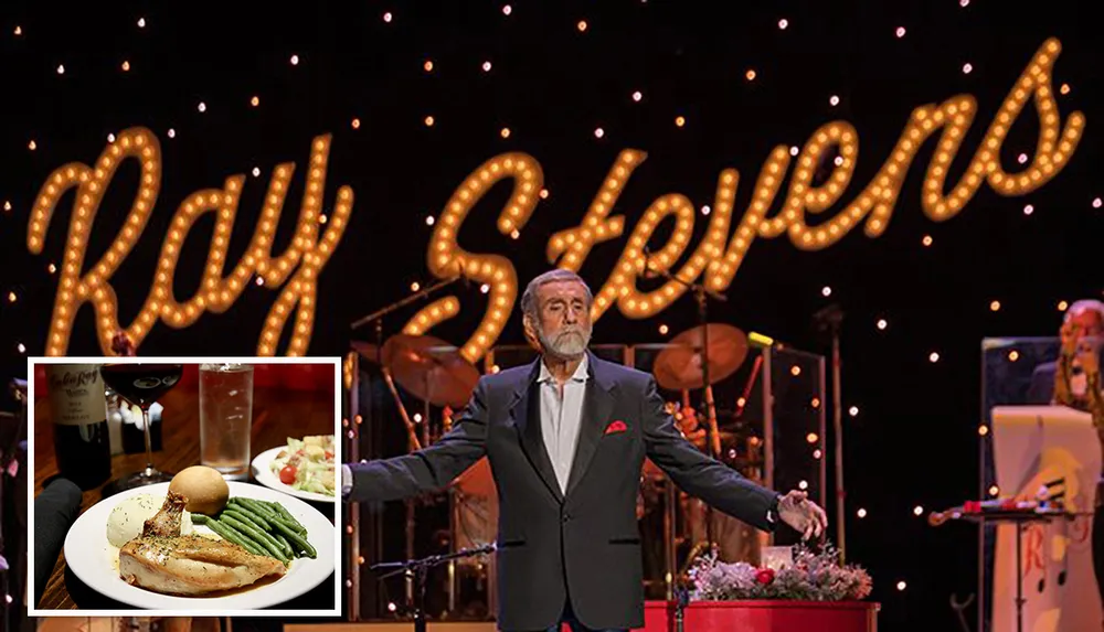 A man stands on stage with arms outstretched in front of a lit sign that displays the name Ray Stevens with musicians in the background