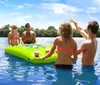 A group of cheerful men in swimwear are having a good time on a boat some holding beverages on a sunny day