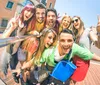 A group of cheerful young people are taking a selfie together on a sunny day