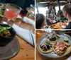 The image showcases a gourmet burger with a side of what appears to be a bean dish and a pink cocktail on a wooden restaurant table