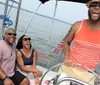 A smiling man and woman are enjoying a sunny day on a sailboat