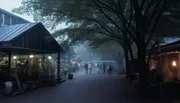 The image depicts a misty outdoor scene at dusk with people walking between stalls and canopies, highlighted by soft lighting from lamps and storefronts, evoking a tranquil, almost ethereal atmosphere.