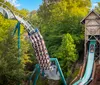 A group of four friends are walking and laughing together on a wooden bridge with a roller coaster in the background on a sunny day