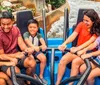 A group of people are enjoying a thrilling ride on a roller coaster displaying a mix of excitement and exhilaration