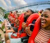 A group of people are enjoying a thrilling ride on a roller coaster displaying a mix of excitement and exhilaration