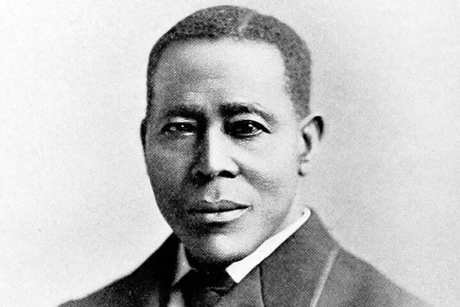 The image is a black and white portrait of Scott Joplin, an African American composer and pianist known as the King of Ragtime.