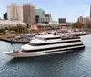 A large multi-deck boat with passengers is docked near a busy waterfront area with the Waterside sign in the background