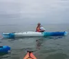 Two people are smiling while kayaking together on a sunny day