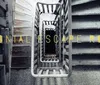 The image shows a descending spiral staircase with the phrase COLONIAL ESCAPE ROOM written in yellow across the steps suggesting an atmospheric setting for an escape room adventure