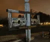 An old wooden pillory stands ominously in nightfall perhaps a historic relic or a reproduction typically used in the past for public humiliation and punishment