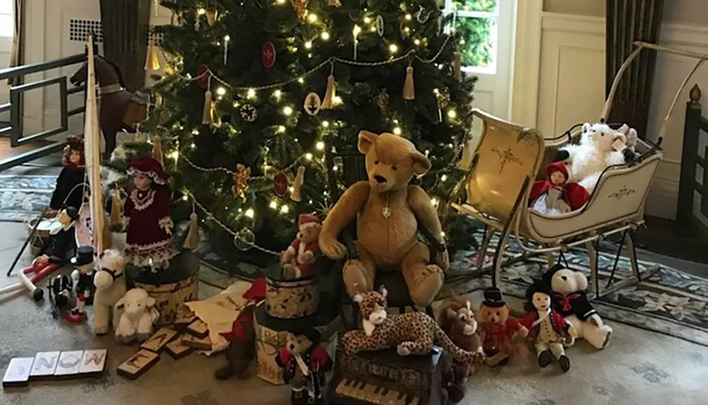 A festive scene with a richly decorated Christmas tree surrounded by an assortment of plush toys and holiday ornaments