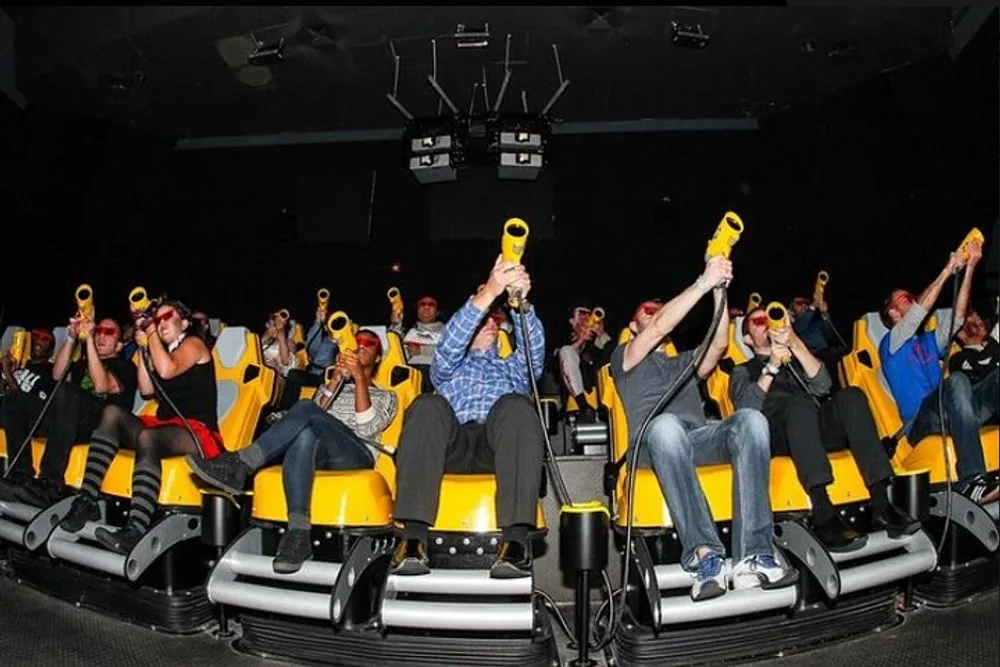 A group of people are enjoying an immersive 4D cinema experience with motion seats and special effects