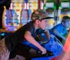 A person is driving a go-kart on an indoor track under the branding of Andretti Indoor Karting  Games with the slogan Setting entertainment on a whole new track