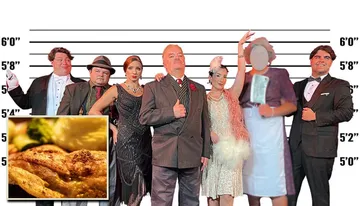 Seven people dressed in vintage formal attire stand in front of a height chart backdrop.