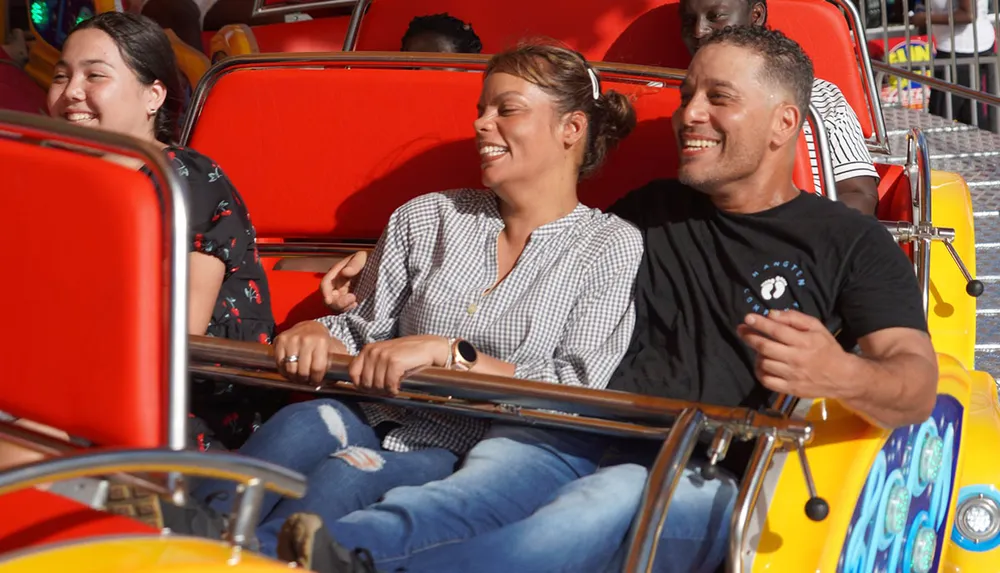 People are laughing and enjoying a fun ride at an amusement park