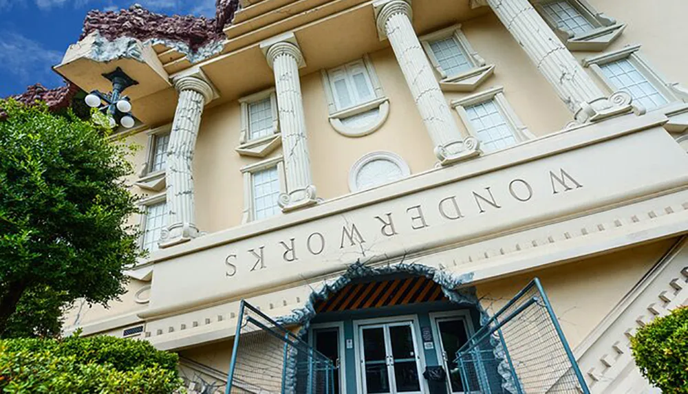 The image shows a building designed to look like an upside-down structure with the sign WonderWorks inverted creating an unusual and eye-catching architectural landmark