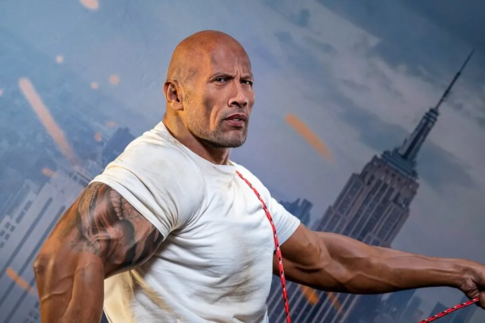 The image shows a muscular person posing confidently with a serious expression in front of a backdrop featuring a city skyline
