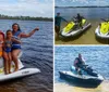 A family of four is posing with thumbs up on a yellow jet ski in a large body of water surrounded by trees under a partly cloudy sky