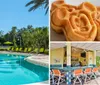 A tranquil outdoor swimming pool area surrounded by lush greenery and lined with yellow umbrellas and green sun loungers under clear blue skies