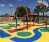 This is a colorful outdoor childrens splash pad with playful water features and seating areas under a sunny sky