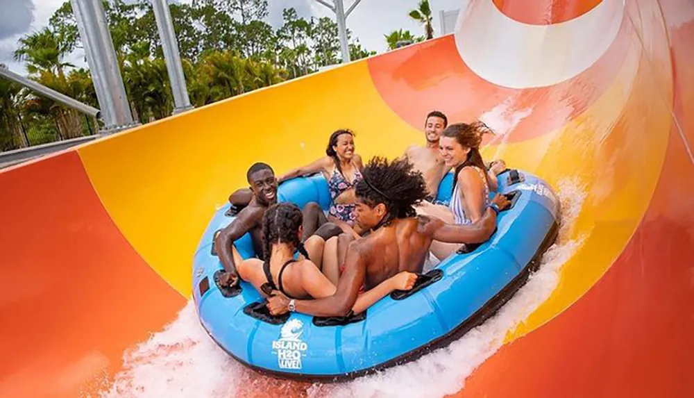 A group of people are enjoying a water slide ride together in an inflatable raft