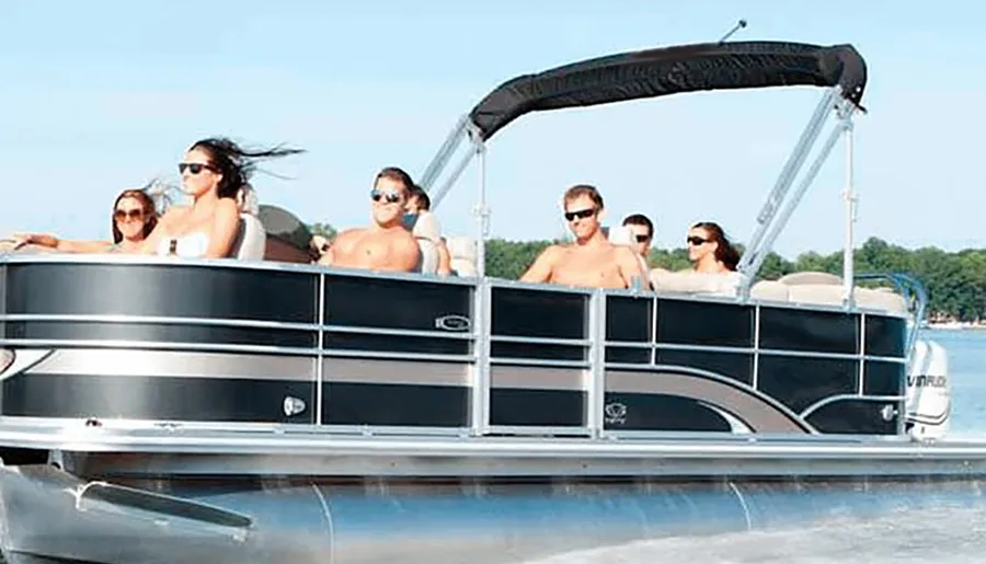 A group of people are enjoying a sunny day on a pontoon boat.