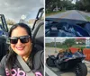 A person is seated in a parked Polaris Slingshot three-wheeled vehicle smiling and holding the steering wheel